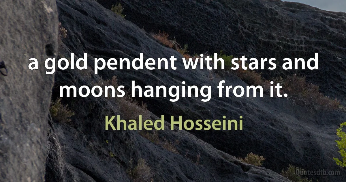 a gold pendent with stars and moons hanging from it. (Khaled Hosseini)